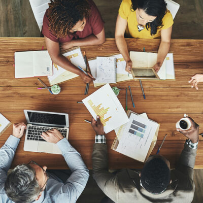 High angle shot of a team of businesspeople meeting around the boardroom table in the office